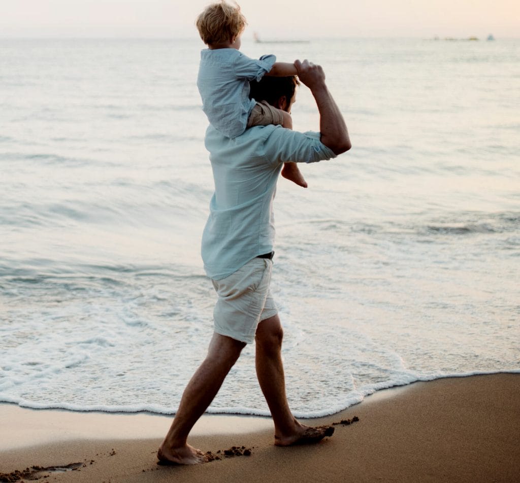 father with a toddler boy walking on beach on summ 2022 02 08 22 39 29 utc